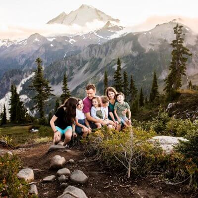 Family sitting on a bench with Mount Baker in the background.