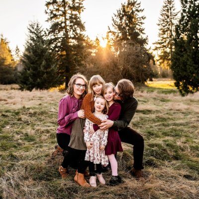 Family cuddled together in a field in Woodinville, Wa.